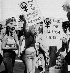 a group of people holding up signs in the street