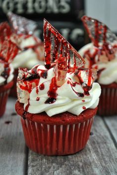 red velvet cupcakes with white frosting and sprinkles on top