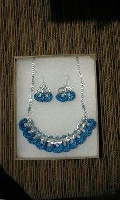 a necklace and earring set in a box