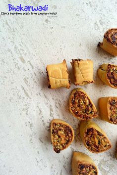 several pieces of food sitting on top of a white counter next to some crackers