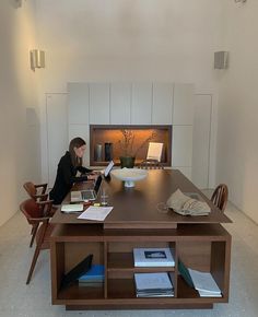 a person sitting at a table with a laptop