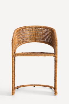 a chair made out of wicker sitting on top of a white surface