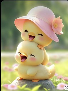 two little ducks are hugging each other in the grass with pink hats on their heads