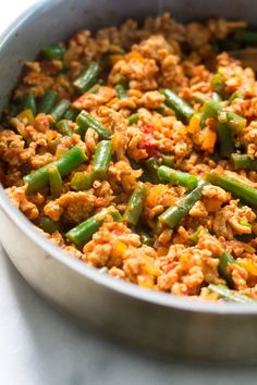 a pan filled with meat and green beans