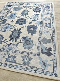 a blue and white rug is on the floor in front of a wood flooring area