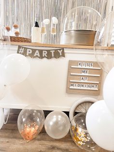 balloons and confetti are on the table at a party