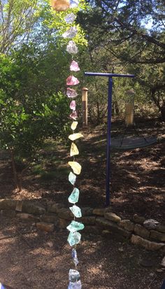 a glass wind chime in the middle of a park