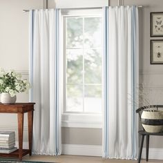 a living room with white and blue curtains