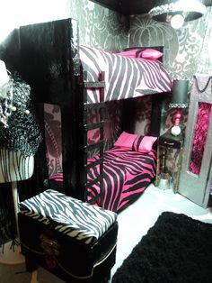 a zebra print bunk bed with pink and black decor on the walls, next to a mirror