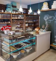 a bakery filled with lots of different types of cakes and cupcakes on display