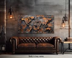 a living room with a leather couch and a large metal world map on the wall