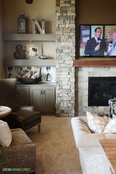 a living room filled with furniture and a flat screen tv mounted on the wall above a fireplace