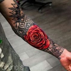 a man with a rose tattoo on his arm