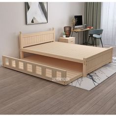 a wooden bed frame sitting on top of a hard wood floor next to a desk