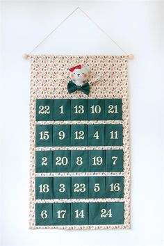 a wall hanging with numbers and a teddy bear