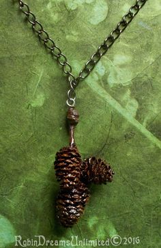 "This necklace is 18 1/4\" round the neck with a pendent that drops 2 1/4\" below the chain.  This necklace weighs 7.56 grams. The pendent is a group of three alder pinecones hanging from a 3.5 mm by 5.5 mm gunmetal curb chain which is clasped with a lobster clasp 6 mm by 12 mm. The lobster clasp can attach anywhere along the chain which ends in a 5 mm jump ring, to adjust to any length needed.  I gathered the alder pinecones from the Arcata area of California over the year 2015.  They are natur Pinecone Necklace, Oval Earring, Curb Chain, Jump Rings, Pine Cones, Lobster Clasp, Jewelry Necklace Pendant, Necklace Lengths, The Year