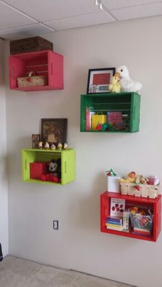 there are three shelves on the wall with toys