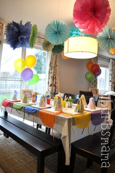 a dining room table with colorful paper decorations