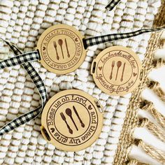 three wooden badges with the words, spoons and fork on them sitting on a woven surface