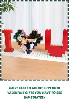 a man and woman kissing in front of legos