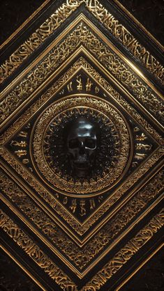 a gold and black clock with a skull in the middle on it's face