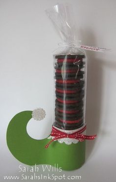 chocolate cookies wrapped in cellophane and tied to a green ribbon with a red bow