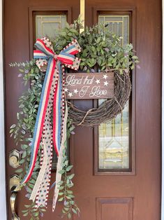 a patriotic wreath hanging on the front door