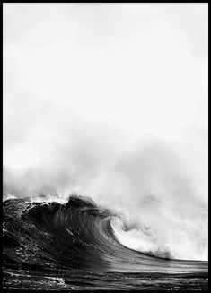 a black and white photo of a wave in the ocean