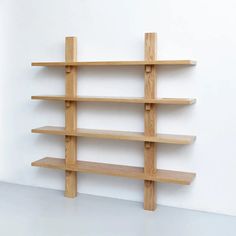 a wooden shelf sitting on top of a white wall