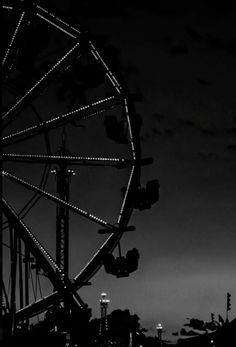 the ferris wheel is lit up at night