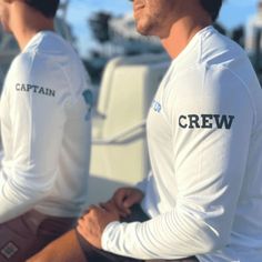 Custom boat and fishing shirts for your entire crew. ✓ Captain or Crew Text Print Along Sleeve ✓ Front & Back Design Printing ✓ SPF 50 Dri-Fit Materials White Sailor Style Long Sleeve Tops, Casual White Long Sleeve Rash Guard, White Long Sleeve Moisture-wicking Rash Guard, White Nautical Tops For Sailing, White Long Sleeve Tops For Team Events, White Long Sleeve Tops For Outdoor Activities, Fishing Hoodies, Boat Shirts, Fishing Charters