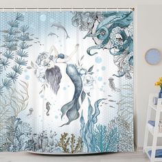 a shower curtain with an image of a mermaid and sea animals in the ocean on it