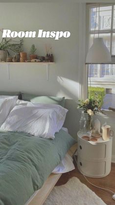 an unmade bed sitting in a bedroom next to a window with potted plants on it