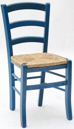 a blue chair with a wicker seat and back rests against a white background,