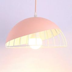 a pink light hanging from a ceiling fixture