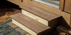 two wooden steps leading up to a window