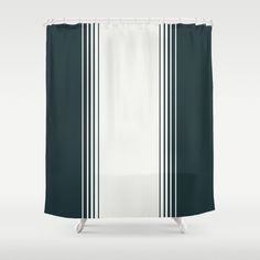 a white shower curtain with black and white stripes on the bottom, in front of a gray background