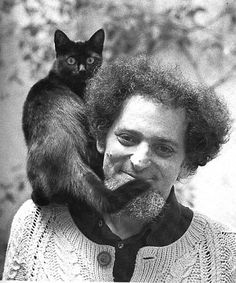 a man holding a cat on his shoulders