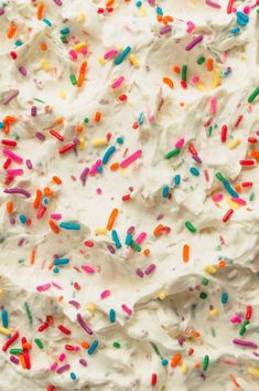 white frosted cake with colorful sprinkles on top