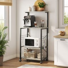 a kitchen with a microwave, toaster oven and potted plant in the corner