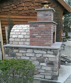 a brick oven sitting on the side of a building