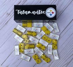 yellow and white dominos are scattered on the floor next to a pittsburgh football logo