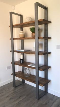 a wooden shelf with shelves and vases on top of it in a living room