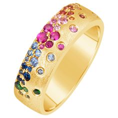 This vibrant piece showcases a 5.75mm band, meticulously crafted from 14 karat yellow gold (14KY) and adorned with a luxurious satin finish. A dazzling array of rainbow sapphires and tsavorites, totaling 0.62 carats, are seamlessly flush-set into the band, creating a kaleidoscope of color. Ring Size: 6.5 This ring is available in custom sizes. Please contact us with your preferred size for a price quote and estimated delivery time. Tsavorite Ring, Colored Stone Rings, Rainbow Sapphires, Rainbow Gemstones, Sapphire Band, Sapphire Diamond Ring, Rose Gold Diamonds, Brilliant Diamond, Exquisite Jewelry