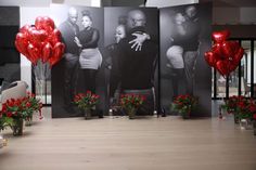 two red balloons are in front of three black and white photos with flowers on the floor