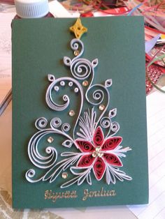 a christmas card with an ornament in the shape of a poinsetti