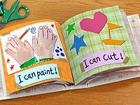 an open children's book on a wooden table with scissors and crayons