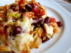 a white plate topped with pasta and meat