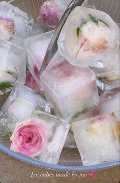 ice cubes with flowers in them are being cut into small squares and placed on top of each other