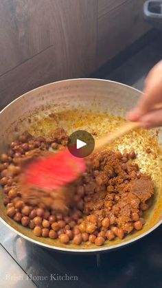 someone is stirring some food in a pan